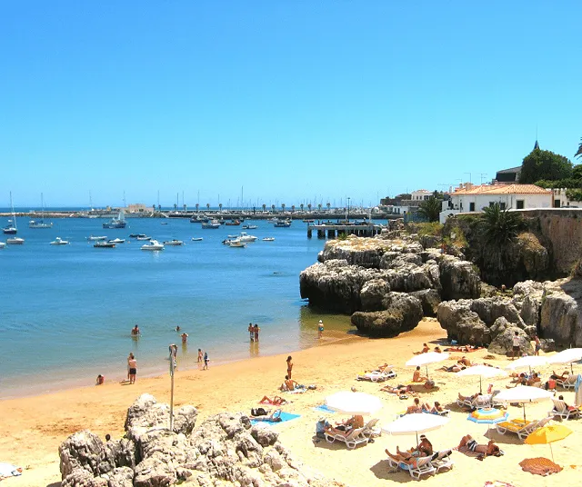 One of the beaches in Cascais with boats moored off shore