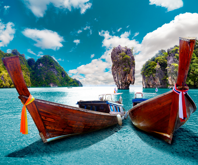 two boats sat on a phuket beach