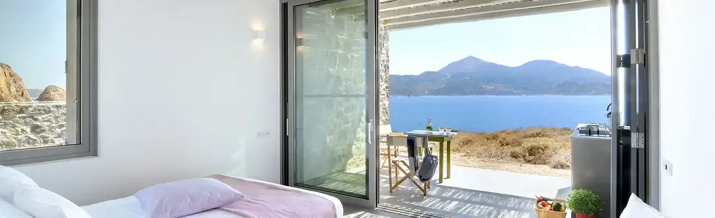 a bedroom looking out over the sea