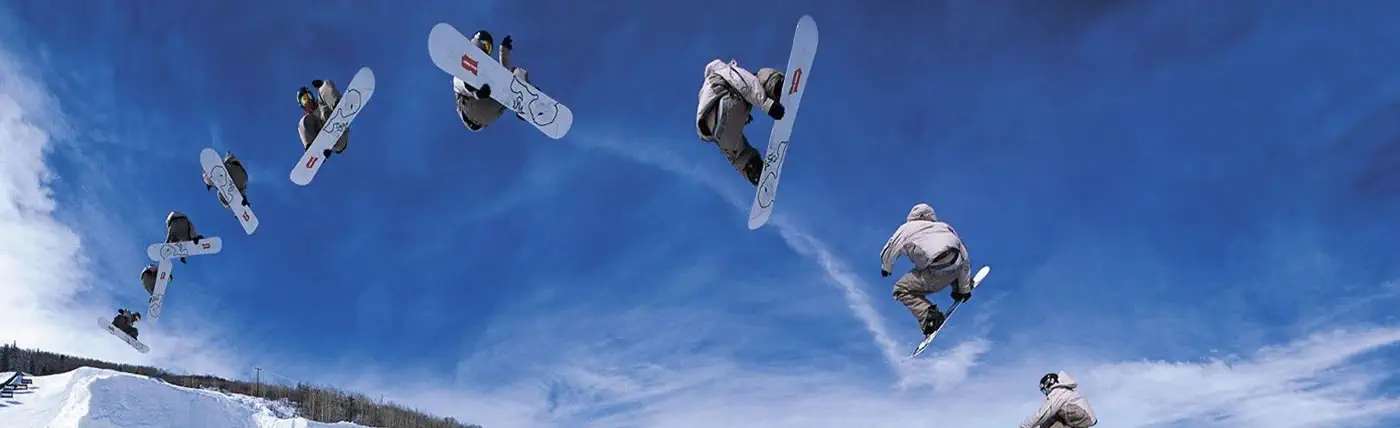 a time progression of a snowboarder jumping